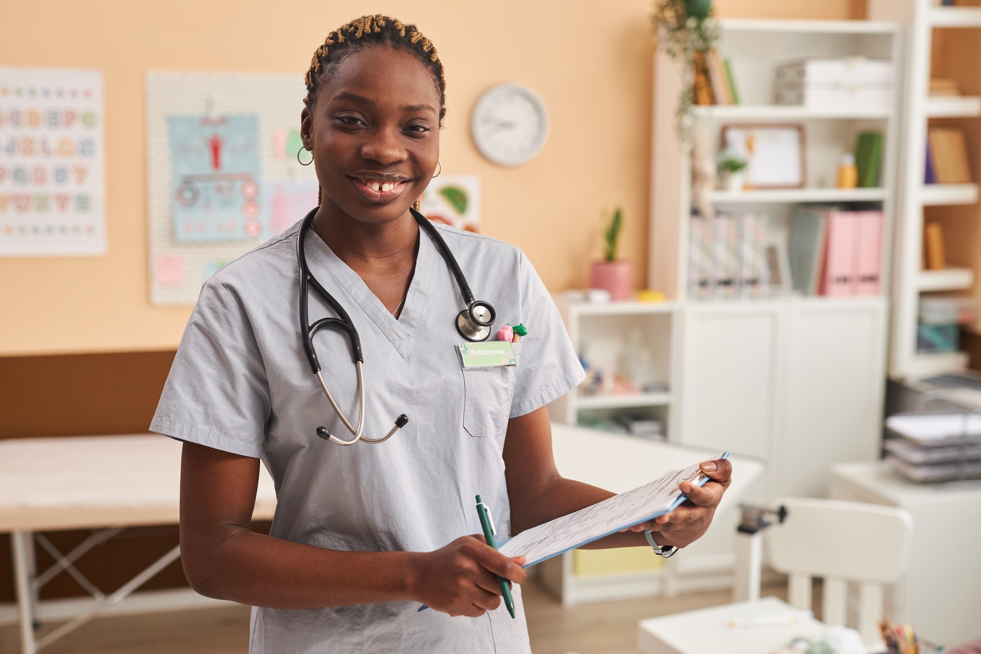 Young Black Nurse Looking at Camera in Clinic